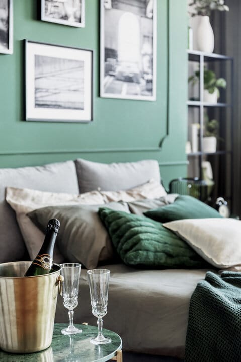 Candace Bosch | EXP Realty | Top 10 Tips to Successful Home Staging | Cozy bed with pillows and blankets in emerald and grey colors